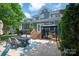 Relaxing backyard patio with dining set, grill, and stairs leading to the home at 189 Mills Ln, Fort Mill, SC 29708