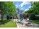 Spacious backyard featuring a dining area, lounge chairs, and a cozy fire pit at 189 Mills Ln, Fort Mill, SC 29708