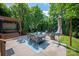 Well-designed backyard featuring a dining area, hot tub, and fire pit with green foliage at 189 Mills Ln, Fort Mill, SC 29708