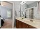 Bathroom featuring double sinks, cherrywood cabinetry, and modern fixtures, open to bedroom at 189 Mills Ln, Fort Mill, SC 29708