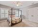 Cozy bedroom with a canopy bed, natural light from shuttered windows, and a soft, neutral carpet at 189 Mills Ln, Fort Mill, SC 29708