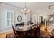 Charming dining room with hardwood floors, shuttered windows, chandelier, and decorative table setting at 189 Mills Ln, Fort Mill, SC 29708