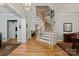 Bright foyer showcasing hardwood floors and a staircase with white railing and wood treads at 189 Mills Ln, Fort Mill, SC 29708