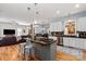 Spacious kitchen with granite countertops, stainless appliances, hardwood floors, island with seating, and open to living room at 189 Mills Ln, Fort Mill, SC 29708