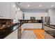 Beautiful kitchen featuring stainless steel appliances, dark countertops, tile backsplash, and wood floors at 189 Mills Ln, Fort Mill, SC 29708
