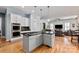 Gourmet kitchen flows into living area, featuring a gas cooktop on the central island and stainless appliances at 189 Mills Ln, Fort Mill, SC 29708