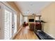 Cozy living area featuring wood floors, bright windows with white shutters, and a modern ceiling fan at 189 Mills Ln, Fort Mill, SC 29708