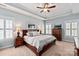 Serene main bedroom with tray ceilings, soft blue walls, and shuttered windows for abundant natural light at 189 Mills Ln, Fort Mill, SC 29708