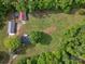 Aerial view of property showing a house, two outbuildings, and the surrounding grassy area at 195 Bluebird Ln, Salisbury, NC 28146