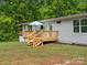 Lovely backyard view of wooden deck with a blue umbrella and green tree backdrop at 195 Bluebird Ln, Salisbury, NC 28146