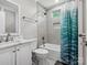 Bright bathroom with a shower and tub combination, neutral tile, and a modern vanity at 195 Bluebird Ln, Salisbury, NC 28146