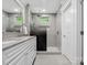 Modern bathroom features a double vanity, glass shower, and gray tile at 195 Bluebird Ln, Salisbury, NC 28146