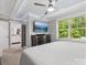 Bright bedroom featuring carpet, a ceiling fan, dresser, television, and a walk-in closet at 195 Bluebird Ln, Salisbury, NC 28146