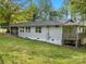Back exterior featuring wooden deck with steps, screened-in porch, lawn, and mature trees at 195 Bluebird Ln, Salisbury, NC 28146