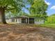 Back of a charming single-story home with a screened-in porch and attached metal carport at 195 Bluebird Ln, Salisbury, NC 28146