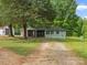Charming single-story home featuring a screened porch and gravel driveway at 195 Bluebird Ln, Salisbury, NC 28146