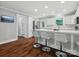 Open kitchen with white cabinets, stainless appliances, large island with bar seating, and hardwood floors at 195 Bluebird Ln, Salisbury, NC 28146