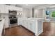 Bright kitchen with white cabinets, marble counters, stainless steel appliances, and an island at 195 Bluebird Ln, Salisbury, NC 28146