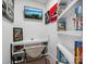 Small office space with white shelving, decorations, and a mounted television at 195 Bluebird Ln, Salisbury, NC 28146