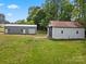 Two outbuildings with large bay doors on a well maintained grassy property at 195 Bluebird Ln, Salisbury, NC 28146