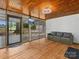 Relaxing screened-in porch with wood plank ceiling, outdoor furniture and a television at 195 Bluebird Ln, Salisbury, NC 28146