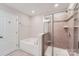 Bright bathroom features a soaking tub and tiled shower with glass door at 19812 Elise Caroline Aly, Davidson, NC 28036