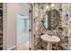 Stylish powder room with pedestal sink and attractive wallpaper at 19812 Elise Caroline Aly, Davidson, NC 28036