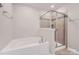 Relaxing bathroom showing a tub and glass shower with tiled surround at 19812 Elise Caroline Aly, Davidson, NC 28036