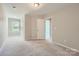 Bright room with neutral walls and carpet, a window, and an entrance to another room at 19812 Elise Caroline Aly, Davidson, NC 28036