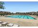 Community pool surrounded by lounge chairs and well-maintained townhomes at 19812 Elise Caroline Aly, Davidson, NC 28036