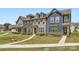 Charming townhomes showcase varied exteriors and landscaping, creating inviting curb appeal on a sunny day at 19812 Elise Caroline Aly, Davidson, NC 28036