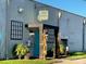 Rumor Mill Market building exterior with modern entrance and vibrant turquoise door at 19812 Elise Caroline Aly, Davidson, NC 28036