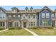 Townhome exterior showcasing a well-manicured lawn and varied facade offering appealing curb appeal at 19812 Elise Caroline Aly, Davidson, NC 28036