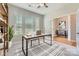 Staged home office with natural light streaming through multiple windows, creating a bright workspace at 19812 Elise Caroline Aly, Davidson, NC 28036