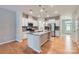 This bright kitchen features stainless steel appliances, a granite-topped island, and hardwood floors for a modern look at 19812 Elise Caroline Aly, Davidson, NC 28036