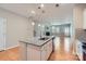 This kitchen features a granite island with a sink, stainless appliances, and hardwood floors throughout the space at 19812 Elise Caroline Aly, Davidson, NC 28036