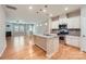 Modern kitchen with stainless steel appliances, a granite island, and pendant lighting, open to living area at 19812 Elise Caroline Aly, Davidson, NC 28036