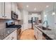 This spacious kitchen features granite counters, stainless steel appliances and white cabinetry at 19812 Elise Caroline Aly, Davidson, NC 28036