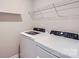 Laundry room with modern washer and dryer, plus storage shelves above at 19812 Elise Caroline Aly, Davidson, NC 28036