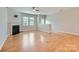 Bright living room with hardwood floors, a fireplace, and large windows providing natural light at 19812 Elise Caroline Aly, Davidson, NC 28036
