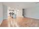 Open-concept living room with hardwood floors connecting to a modern kitchen with stainless steel appliances at 19812 Elise Caroline Aly, Davidson, NC 28036