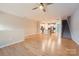 Open-concept living room with hardwood floors flowing into the kitchen and a staircase visible at 19812 Elise Caroline Aly, Davidson, NC 28036