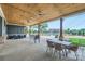 Relaxing outdoor patio area featuring a wood ceiling, tables, and chairs at 19812 Elise Caroline Aly, Davidson, NC 28036