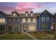 Charming multi-story townhome showcases a well-maintained front lawn and inviting entrance pathway at 19812 Elise Caroline Aly, Davidson, NC 28036