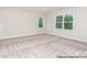 Spacious bedroom with natural light featuring neutral walls and carpeting at 20396 Queens St, Cornelius, NC 28031