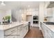Gourmet kitchen featuring a large island, white cabinets, modern appliances, and open floor plan at 20396 Queens St, Cornelius, NC 28031
