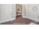 Open double doors lead into the living room featuring hardwood floors and modern decor at 20396 Queens St, Cornelius, NC 28031