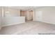 Open loft area featuring plush carpeting and neutral walls with natural light and open hallway at 20396 Queens St, Cornelius, NC 28031