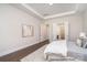 Tranquil main bedroom featuring tray ceiling, hardwood floors, a walk-in closet and an ensuite bathroom at 20396 Queens St, Cornelius, NC 28031
