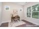 Home office with natural light, hardwood floors, neutral walls, and desk under the windows at 20396 Queens St, Cornelius, NC 28031